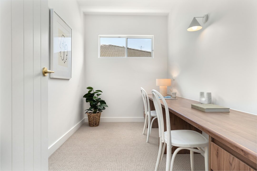 Minimalist boutique real estate office interior with linen and oak furnishings